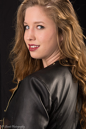 Young adult model looking over shoulder